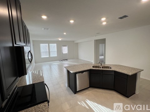 A modern kitchen with granite countertops and a sink.