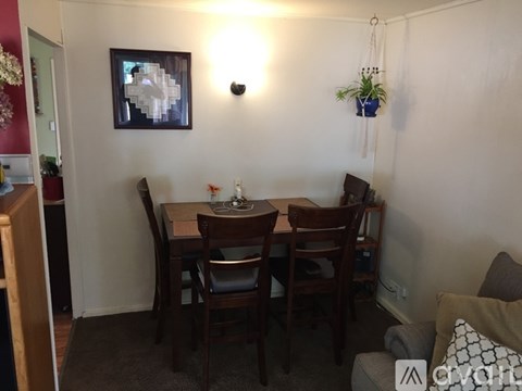 A dining room with a table and chairs.