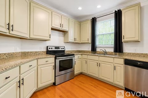 A kitchen with wooden cabinets and a granite countertop.