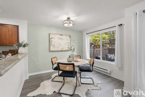 A dining room with a table set for four.