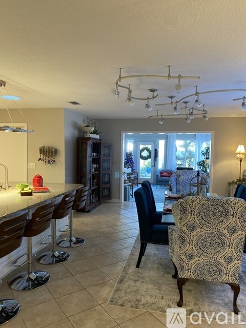 A kitchen with a dining table and chairs.
