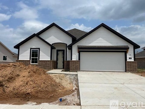 A two-story house with a garage is available for sale.