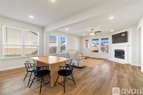A modern dining room with a wooden table and chairs.