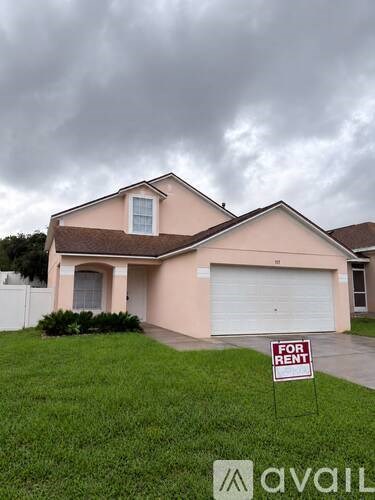 A house is for rent with a sign in front of it.