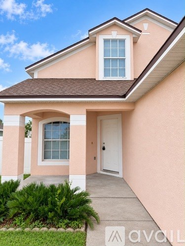 A house with a brown roof and a white door.