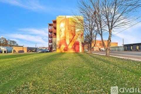 A large mural of a woman's face is displayed on a building.