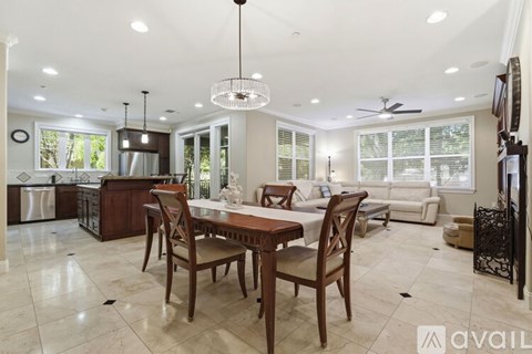 A dining room with a table set for four.