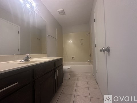 A bathroom with a toilet, sink, and bathtub.