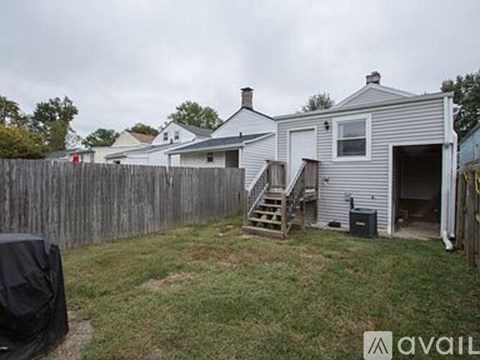 A house with a grey exterior and a wooden fence.