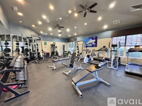 A well-equipped gym with a variety of exercise machines and weights.