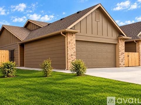 A house with a brown garage door and a brown roof.