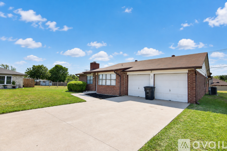 A house with a garage and a driveway is available for sale.