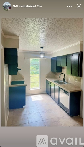 A kitchen with blue cabinets and a white countertop.
