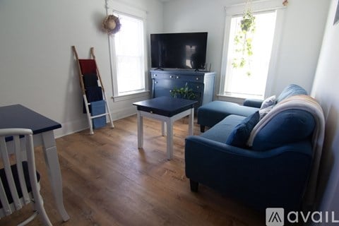 A living room with a blue couch and a television.