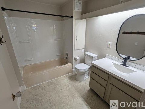 A bathroom with a toilet, sink, and bathtub.