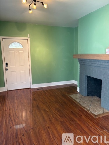 A room with a fireplace and a door.