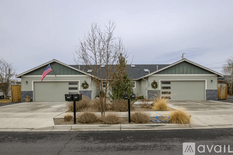 A house with a grey roof and a grey garage door.