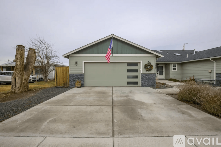 A house with a garage and an American flag on the roof.
