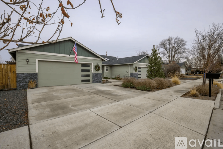 A house with a garage and a flag on it.