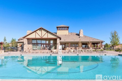 A large house with a pool in front of it.