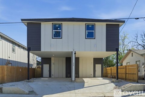 A modern two-story house with a garage and a driveway.