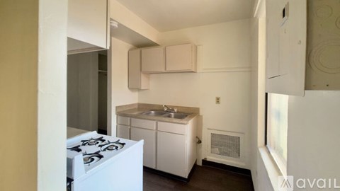 A small kitchen with a stove and sink.
