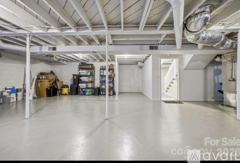 A large, empty warehouse space is available for sale.