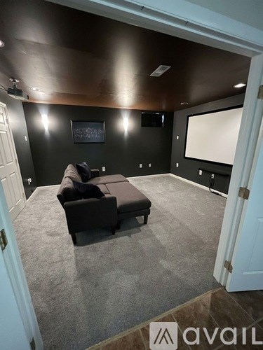 A living room with a grey couch and a flat screen TV.