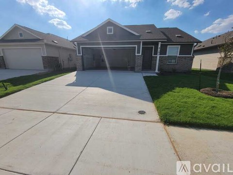 A house with a driveway in front of it is for sale.
