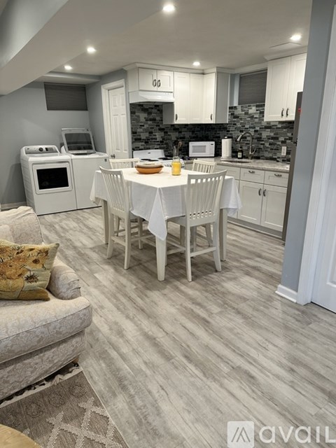 A kitchen with a dining table set for two.