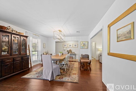 A living room with a dining table and chairs.