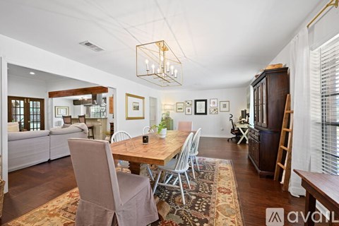 A dining room with a wooden table and chairs.