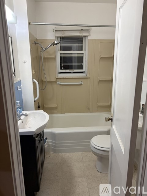 A small bathroom with a toilet, sink, and bathtub.