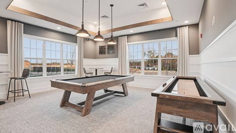 A room with a pool table and a view of the outside.