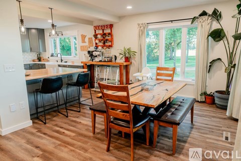 A kitchen with a dining table and chairs.