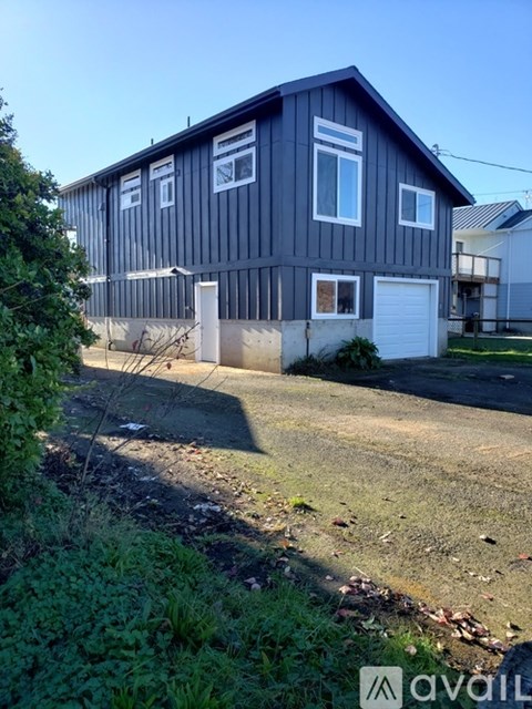A two-story house with a garage is available for rent.