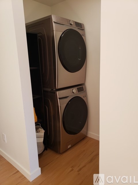 A stack of two washing machines in a laundry room.
