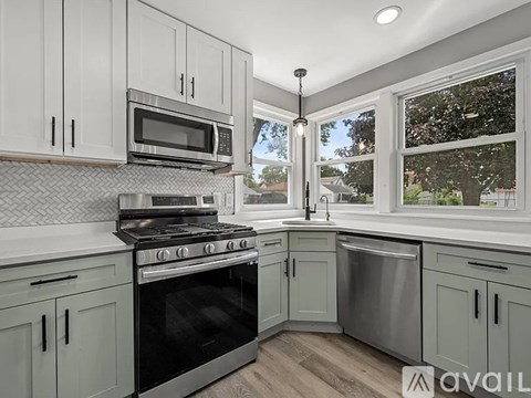 A kitchen with a black oven and a stove top.