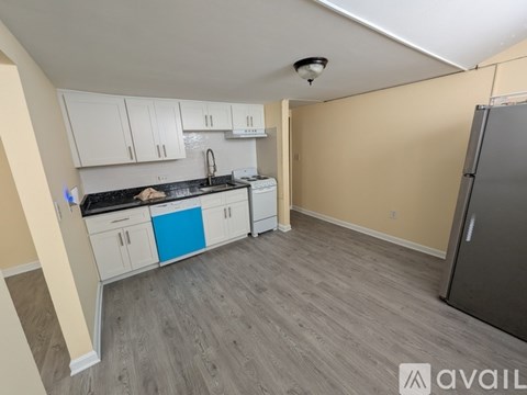 A kitchen with a blue drawer in the middle of the room.