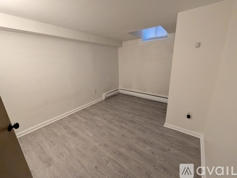 A room with a light grey floor and white walls.