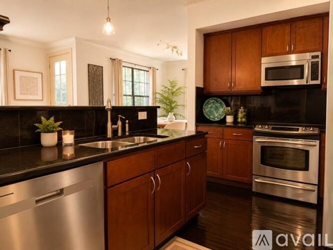 A kitchen with wooden cabinets and stainless steel appliances.