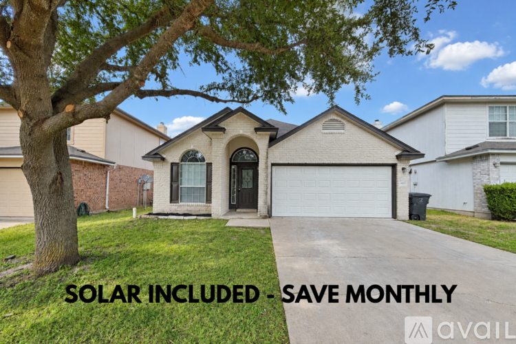 A house with a solar panel advertisement on the front yard.