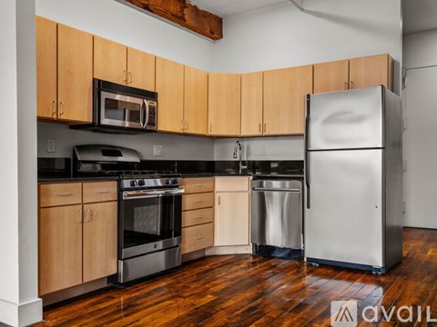 A kitchen with wooden cabinets and stainless steel appliances.
