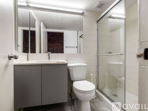 A white toilet sits next to a sink in a small bathroom.