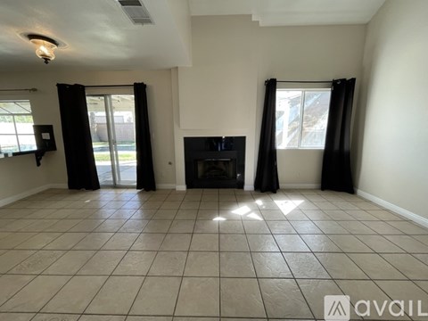 A living room with a fireplace and sliding glass doors.