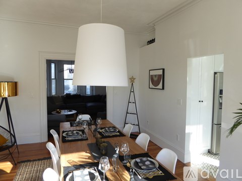A dining room with a table set for a meal.
