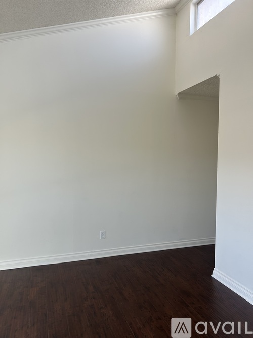 A room with white walls and wood flooring.