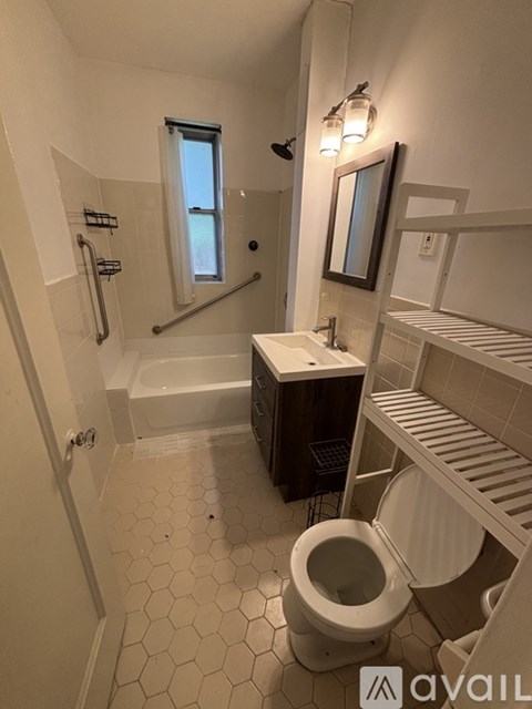 A white bathroom with a toilet, sink, and bathtub.