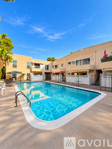 A pool in front of a building with a logo that says "avail".