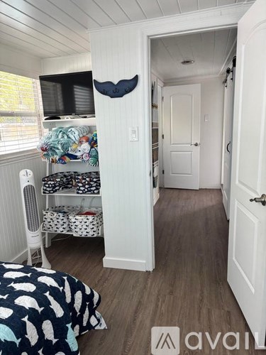 A small bedroom with a bed and a window.
